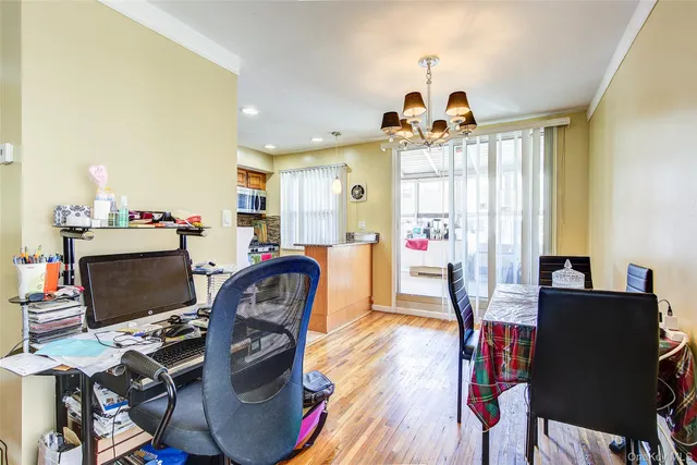 a view of a livingroom with workspace and a window