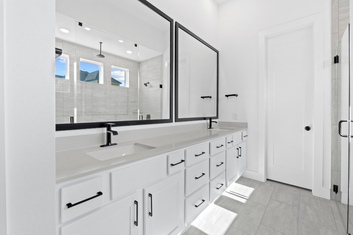 3209 Moon Ridge Road Georgetown, TX 78628 - Photo 14 of 28 a bathroom with a double vanity sink mirror and