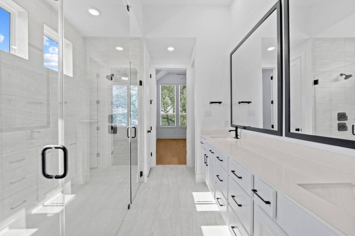 3209 Moon Ridge Road Georgetown, TX 78628 - Photo 16 of 28 a bathroom with a double vanity sink mirror and shower