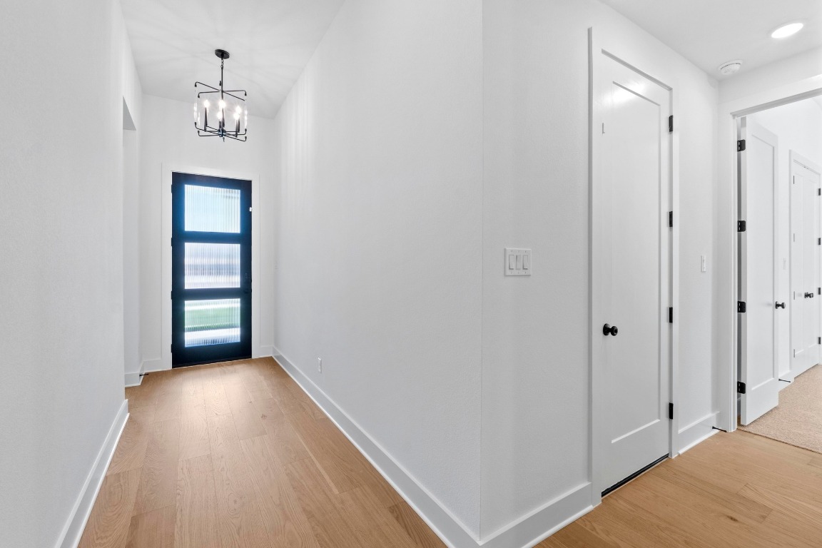 3209 Moon Ridge Road Georgetown, TX 78628 - Photo 19 of 28 a view of a hallway with wooden floor and a bathroom