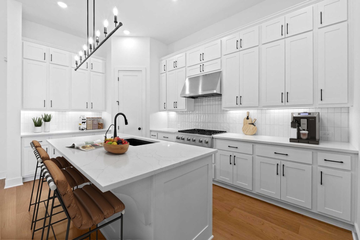 3209 Moon Ridge Road Georgetown, TX 78628 - Photo 2 of 28 a kitchen with a sink a stove and cabinets