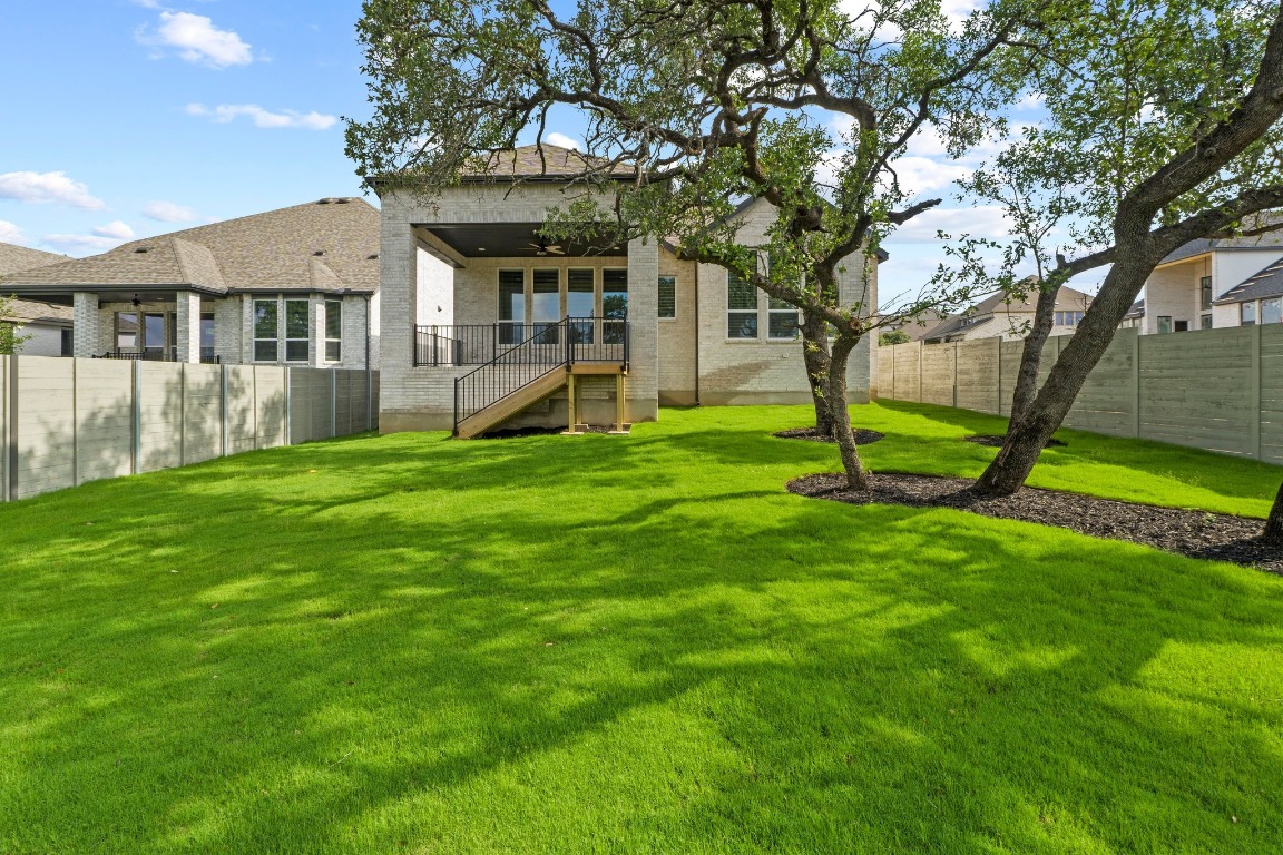 3209 Moon Ridge Road Georgetown, TX 78628 - Photo 27 of 28 a view of a house with a yard
