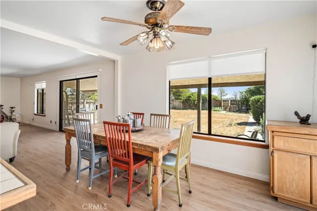 a kitchen with a table chairs sink and cabinets