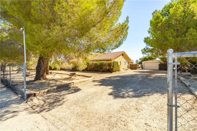 a kitchen with stainless steel appliances granite countertop wooden cabinets a stove a sink and dishwasher with wooden floor