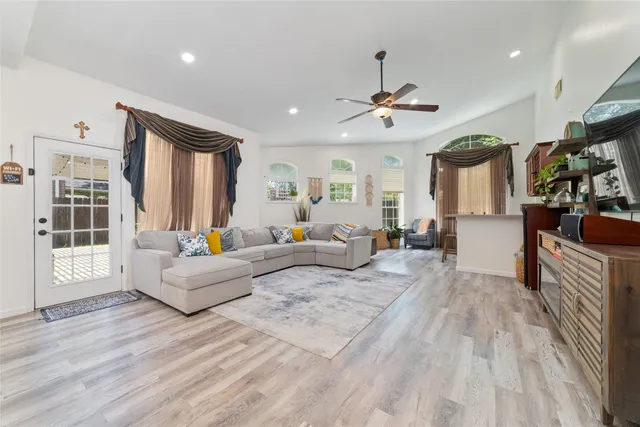 a spacious bedroom with a bed a couch and a chandelier