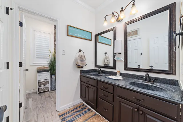 a spacious bathroom with a double vanity sink a mirror and a bathtub