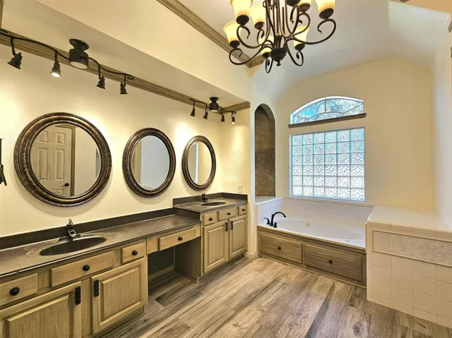 a bathroom with a bathtub and a window