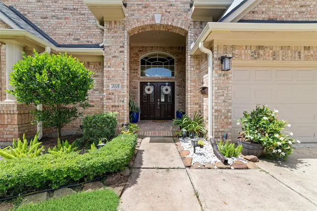 a front view of a house with potted plants