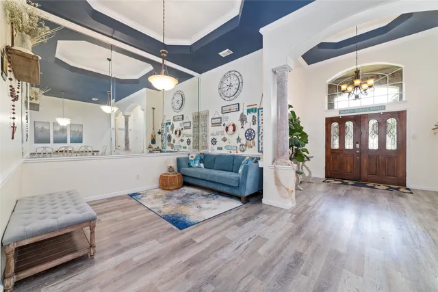 a living room with furniture and wooden floor