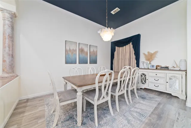 a view of a dining room with furniture window and wooden floor