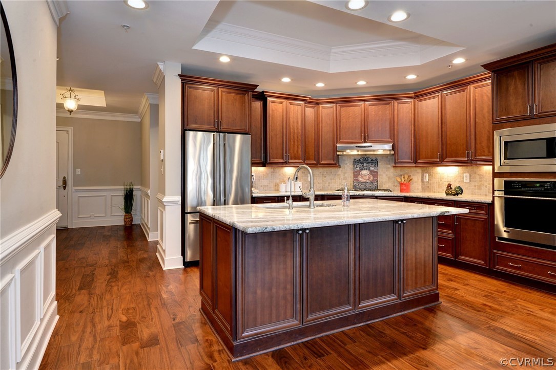 1103 Eaglescliffe Williamsburg, VA 23188 - Photo 11 of 50 a kitchen with kitchen island granite countertop wooden floors wooden cabinets a sink and appliances