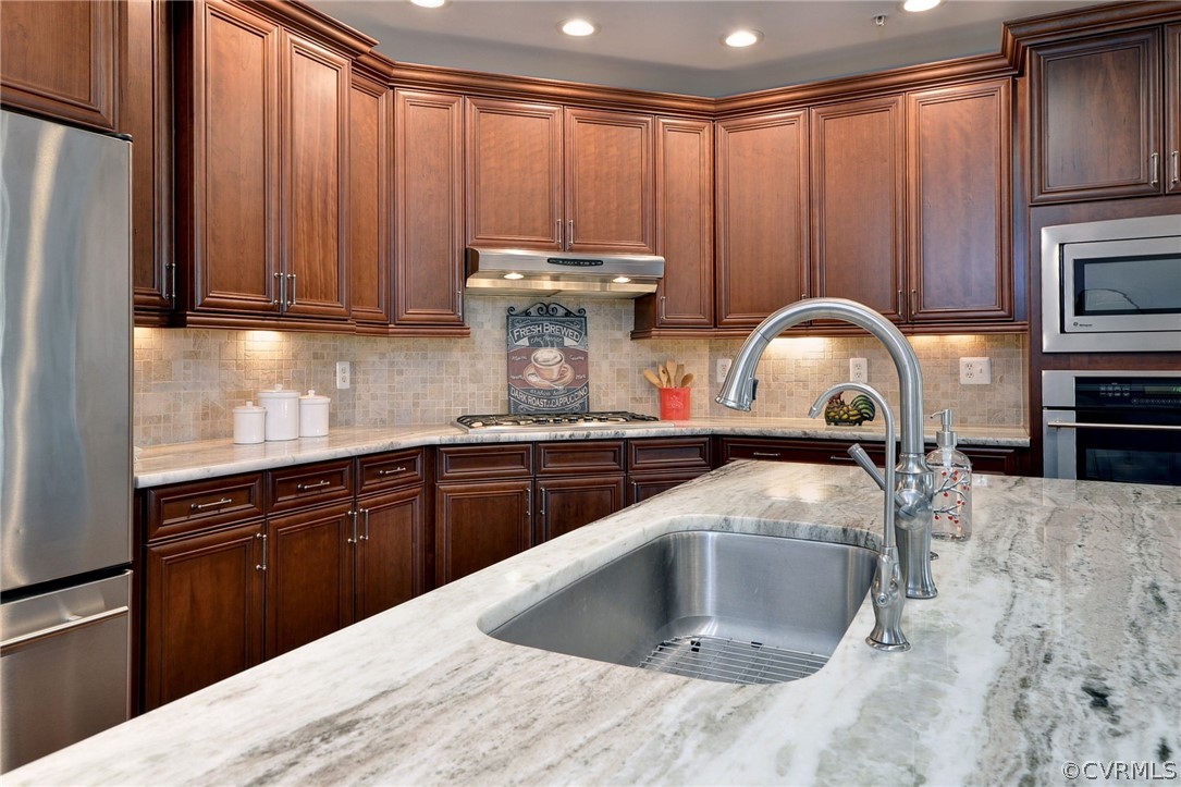 1103 Eaglescliffe Williamsburg, VA 23188 - Photo 14 of 50 a kitchen with kitchen island granite countertop a sink stainless steel appliances and cabinets