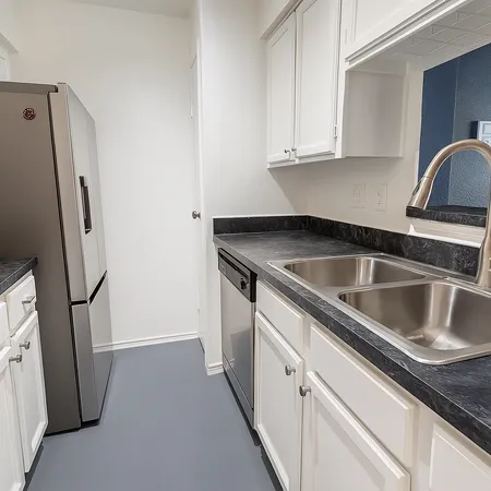 a close view of a sink and washer and dryer