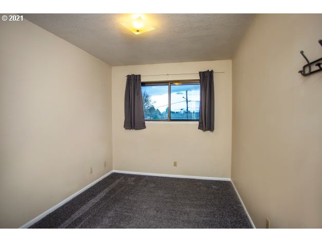 8325 Southwest Terwilliger Boulevard Portland, OR 97219 - Photo 12 of 30 view of an empty room with wooden floor and a window