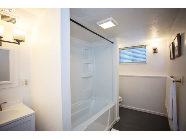 8325 Southwest Terwilliger Boulevard Portland, OR 97219 - Photo 17 of 30 a bathroom with a bathtub sink and mirror
