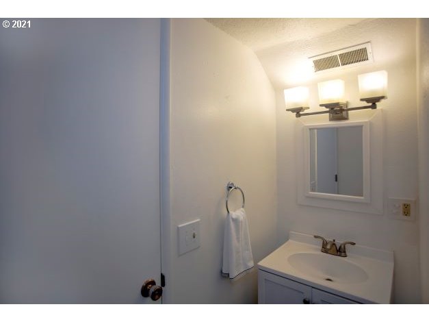 8325 Southwest Terwilliger Boulevard Portland, OR 97219 - Photo 18 of 30 a bathroom with a sink and mirror