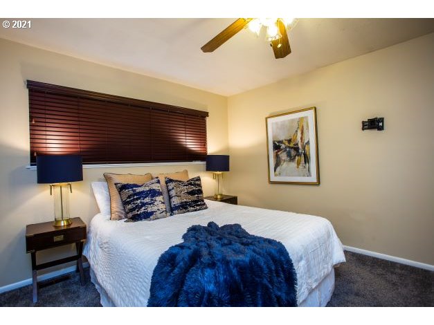 8325 Southwest Terwilliger Boulevard Portland, OR 97219 - Photo 20 of 30 a bedroom with a bed and wooden floor