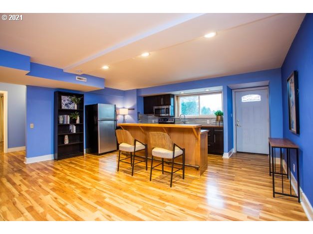 8325 Southwest Terwilliger Boulevard Portland, OR 97219 - Photo 23 of 30 a dining room with furniture and wooden floor