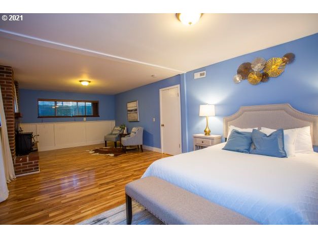 8325 Southwest Terwilliger Boulevard Portland, OR 97219 - Photo 25 of 30 a bedroom with a bed and a view of kitchen