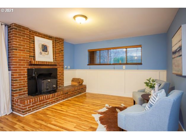 8325 Southwest Terwilliger Boulevard Portland, OR 97219 - Photo 27 of 30 a bedroom with a bed and a fireplace