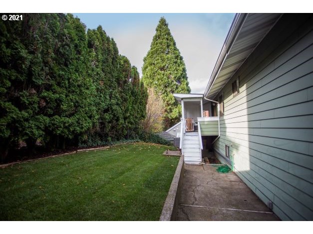8325 Southwest Terwilliger Boulevard Portland, OR 97219 - Photo 29 of 30 a view of an house with backyard and garden