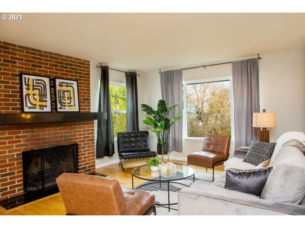 8325 Southwest Terwilliger Boulevard Portland, OR 97219 - Photo 5 of 30 a living room with furniture a large window and a fireplace