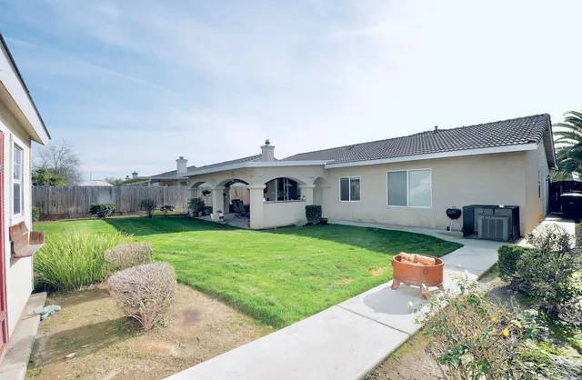 a front view of house with a garden and patio