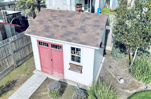 a view of a house with a yard and sitting area