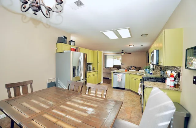 a bed room with a bed mirror and a desk