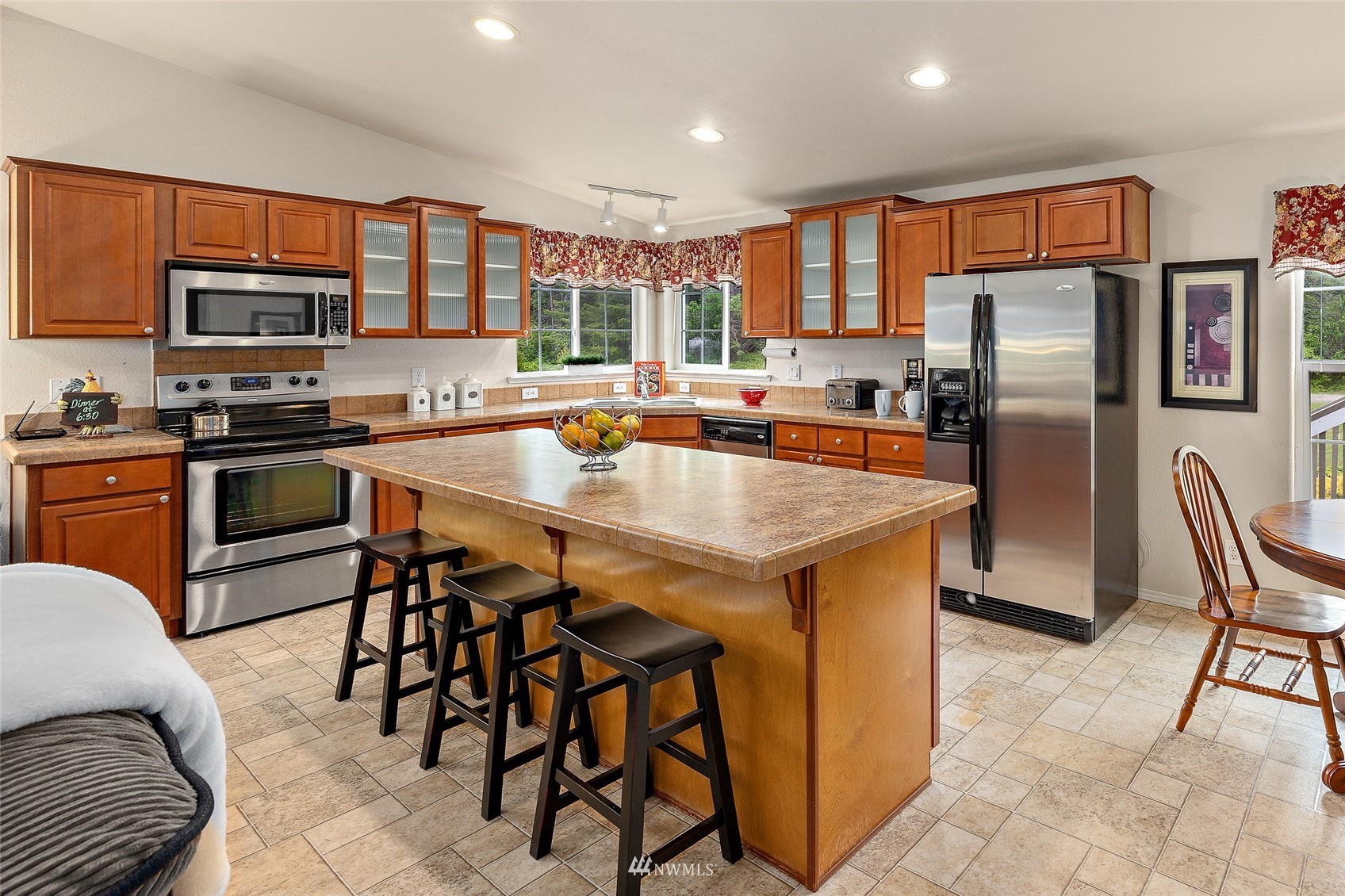 6746 Nelson Siding Road Cle Elum, WA 98922 - Photo 8 of 27 a kitchen with stainless steel appliances granite countertop a stove a refrigerator a stove a sink a dining table and chairs