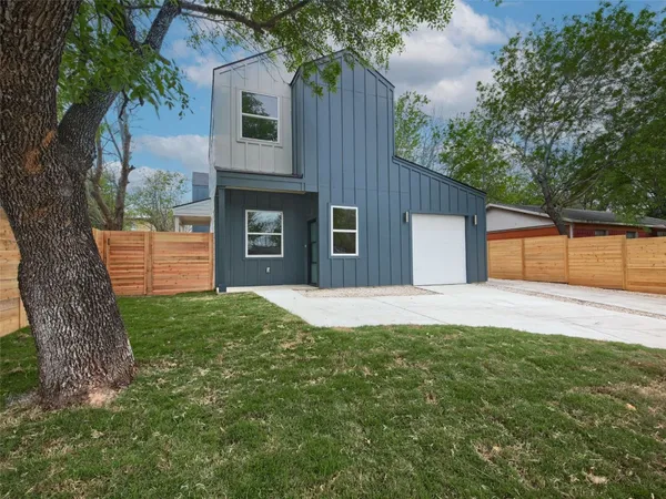 a front view of a house with a yard and a garage