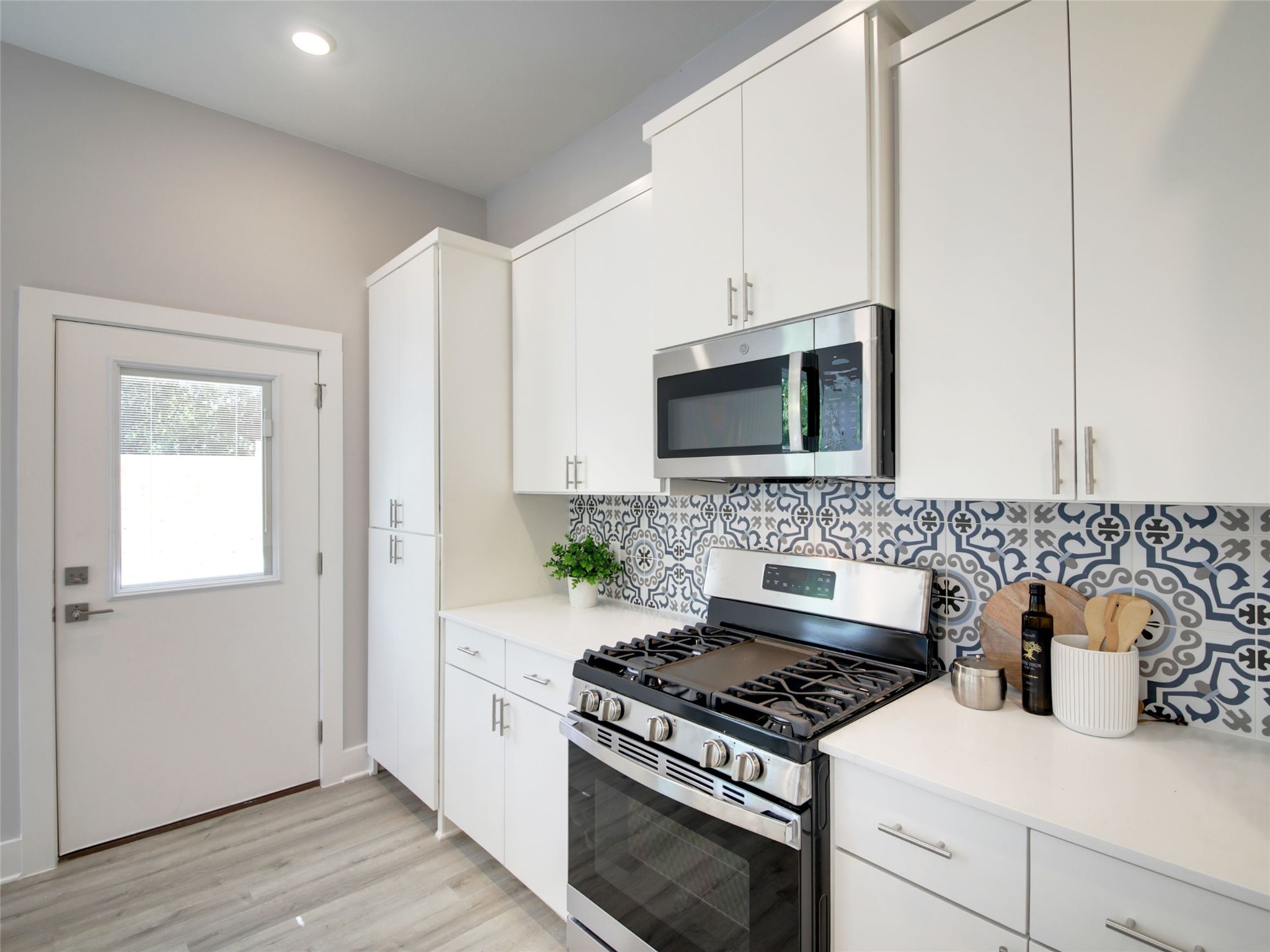 6111 Carnation Terrace, Unit 1 Austin, TX 78741 - Photo 12 of 23 a kitchen with a stove and a microwave