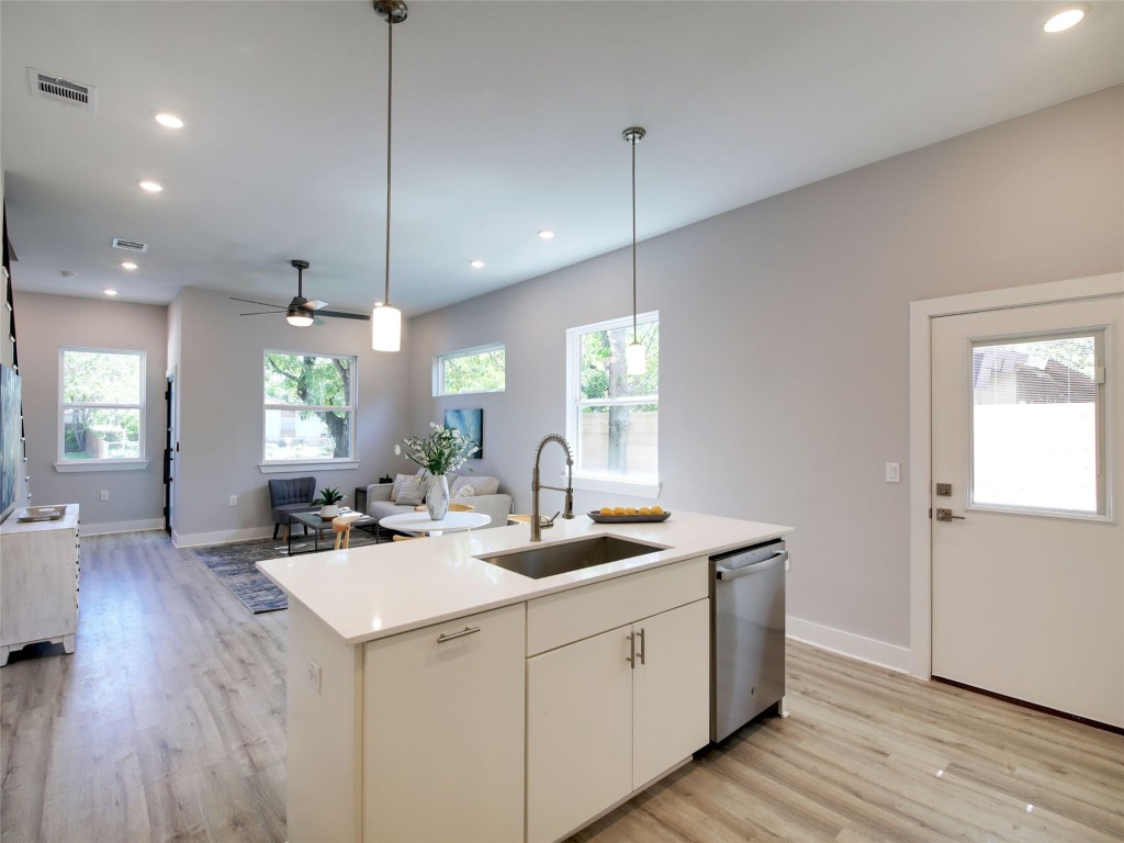 6111 Carnation Terrace, Unit 1 Austin, TX 78741 - Photo 23 of 23 a kitchen with sink stove and wooden floor