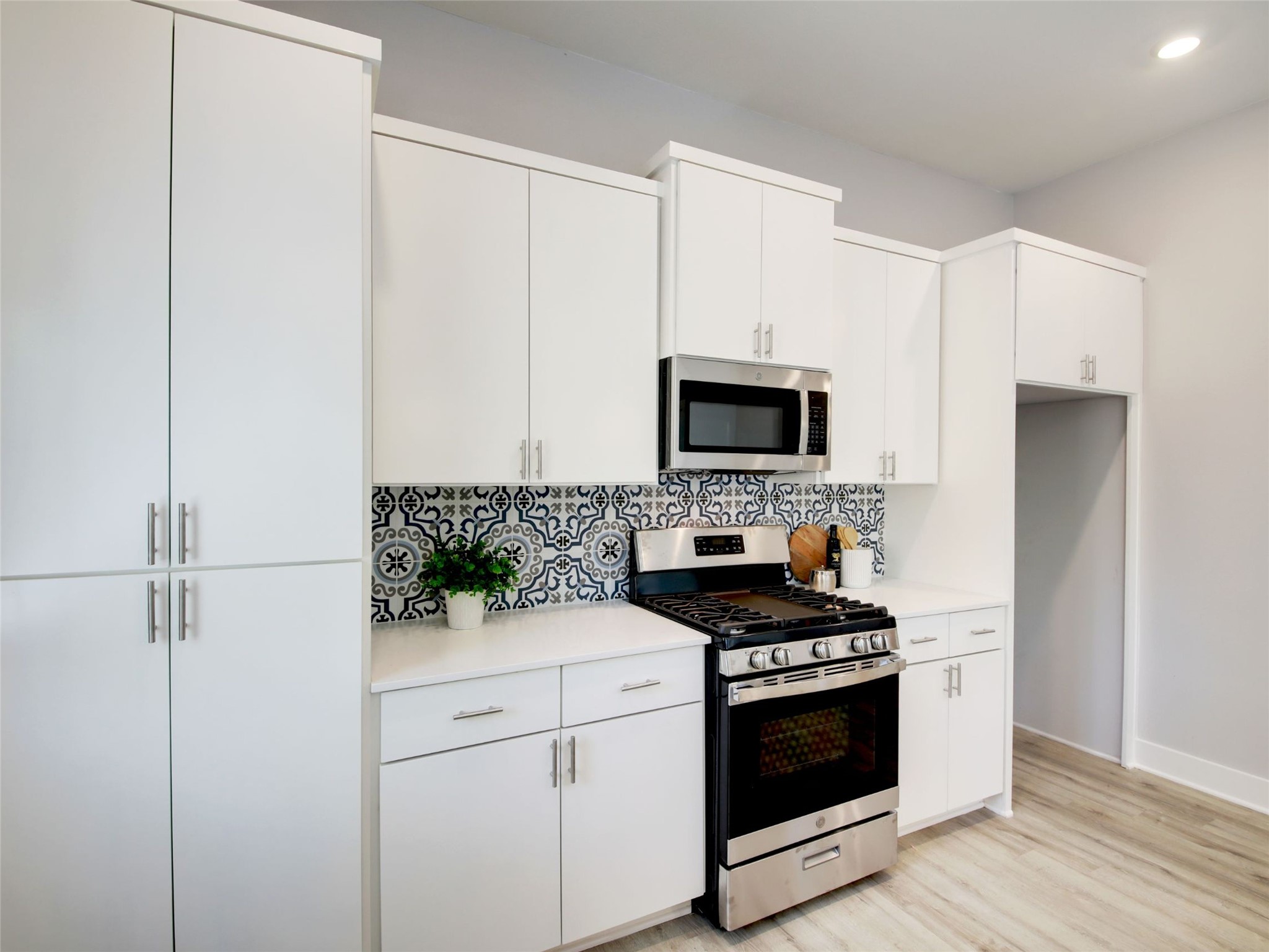 6111 Carnation Terrace, Unit 1 Austin, TX 78741 - Photo 13 of 23 a kitchen with white cabinets and white appliances