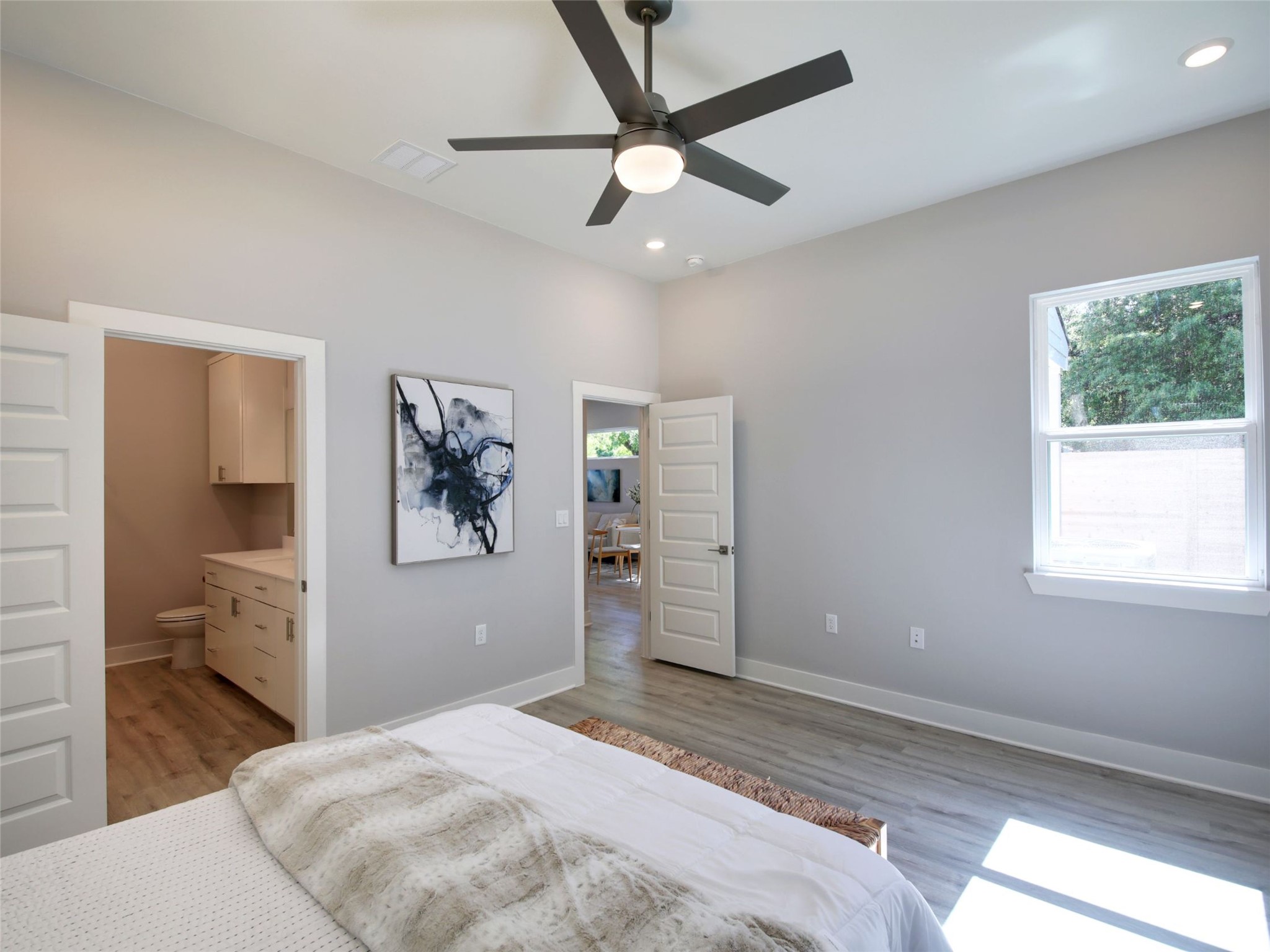 6111 Carnation Terrace, Unit 1 Austin, TX 78741 - Photo 15 of 23 a bedroom with a large bed and a chandelier