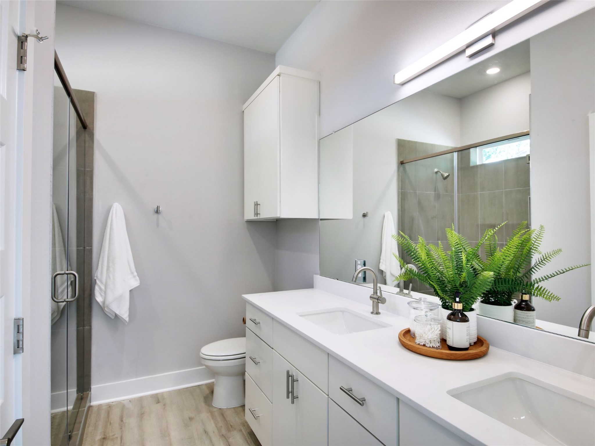 6111 Carnation Terrace, Unit 1 Austin, TX 78741 - Photo 16 of 23 a bathroom with a granite countertop sink a toilet and a mirror