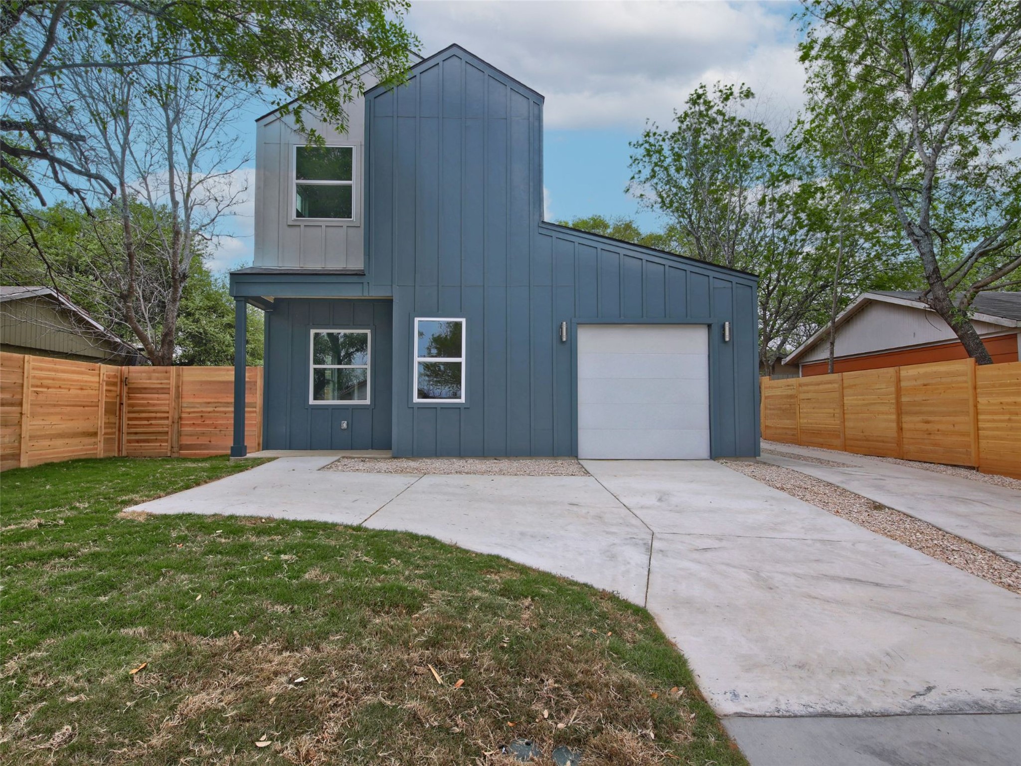 6111 Carnation Terrace, Unit 1 Austin, TX 78741 - Photo 2 of 23 a front view of a house with a yard and garage