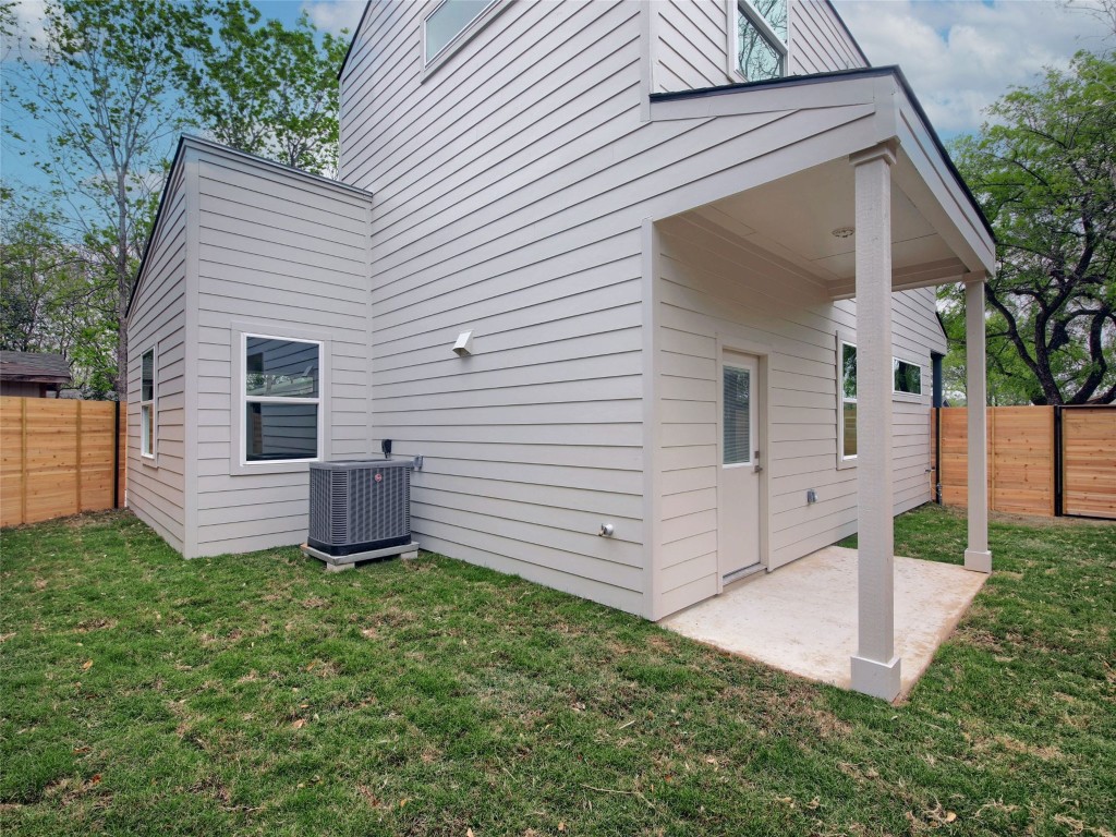 6111 Carnation Terrace, Unit 1 Austin, TX 78741 - Photo 22 of 23 a view of a white house with a yard and a large tree