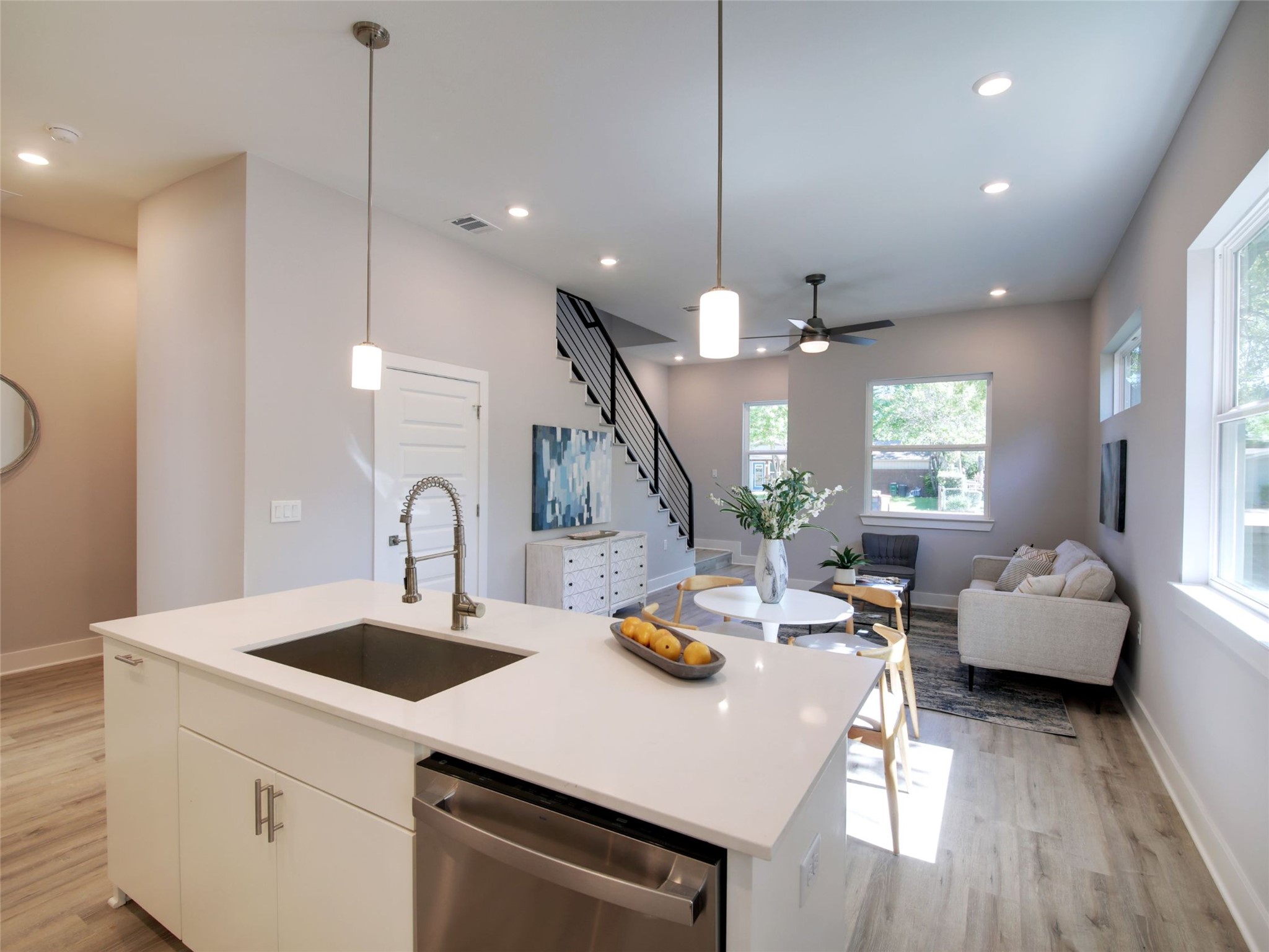 6111 Carnation Terrace, Unit 1 Austin, TX 78741 - Photo 4 of 23 a kitchen with a sink a center island stainless steel appliances and living room view