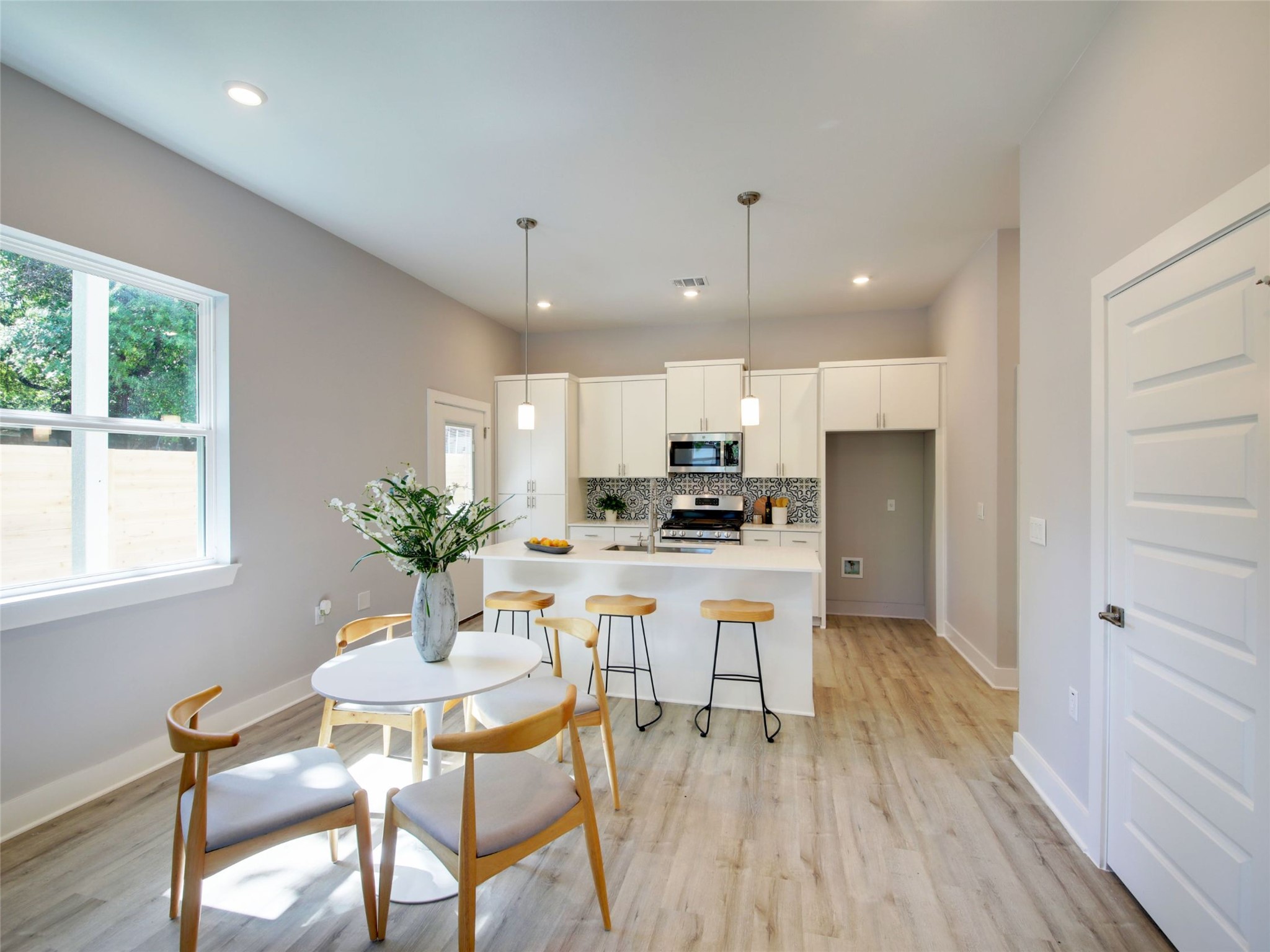 6111 Carnation Terrace, Unit 1 Austin, TX 78741 - Photo 10 of 23 a kitchen with a table and chairs in it
