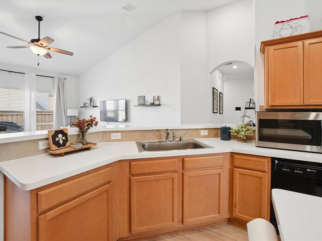 6527 Portside Ridge Lane Dallas, TX 75249 - Photo 13 of 30 a kitchen with sink a stove and cabinets