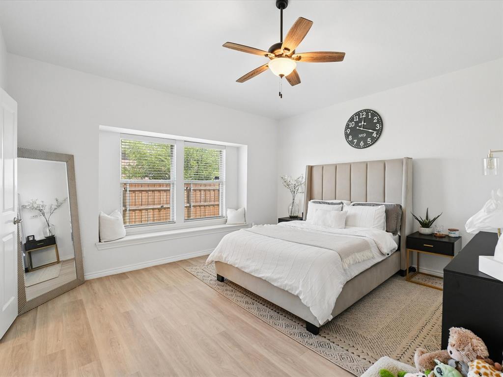 6527 Portside Ridge Lane Dallas, TX 75249 - Photo 19 of 30 a bedroom with a large bed and a window