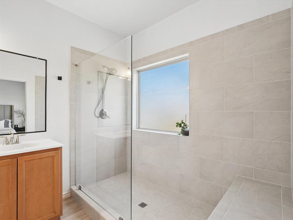 6527 Portside Ridge Lane Dallas, TX 75249 - Photo 21 of 30 a bathroom with a shower and a sink