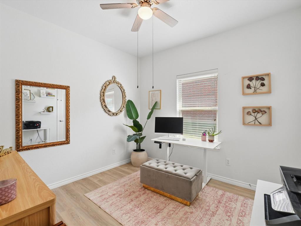 6527 Portside Ridge Lane Dallas, TX 75249 - Photo 23 of 30 a living room with furniture a rug and a mirror