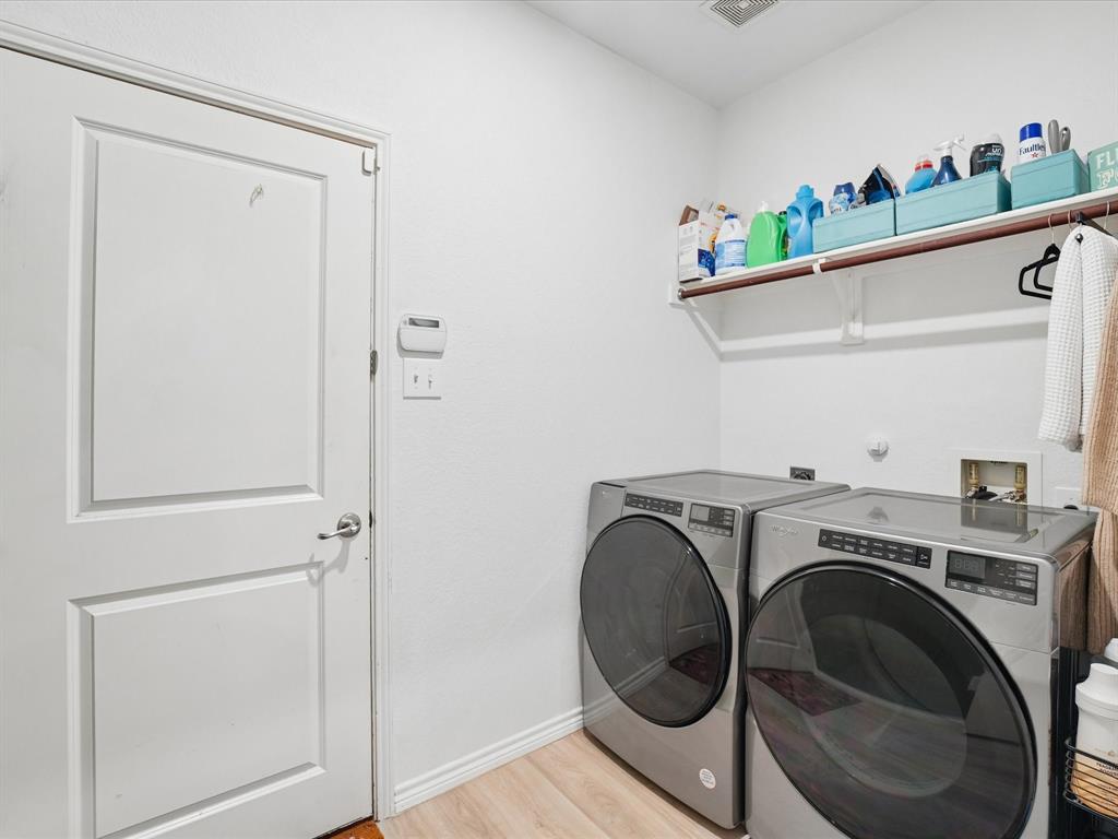 6527 Portside Ridge Lane Dallas, TX 75249 - Photo 25 of 30 a utility room with dryer and washer