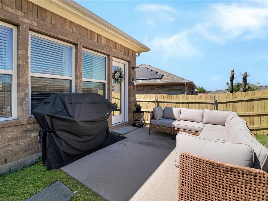 6527 Portside Ridge Lane Dallas, TX 75249 - Photo 27 of 30 a view of a patio with couches and a table and chairs with garden view