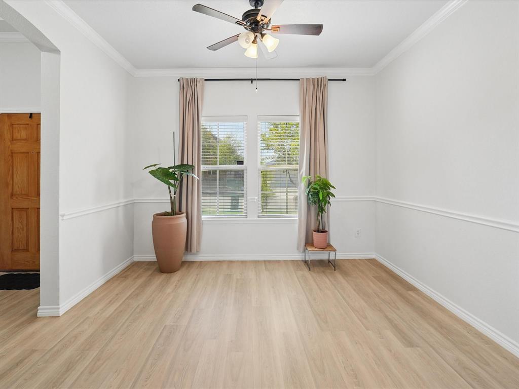 6527 Portside Ridge Lane Dallas, TX 75249 - Photo 9 of 30 an empty room with wooden floor and windows