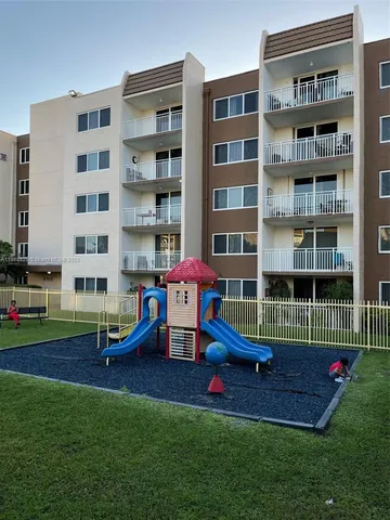 a childrens park with lots of furniture and tall trees