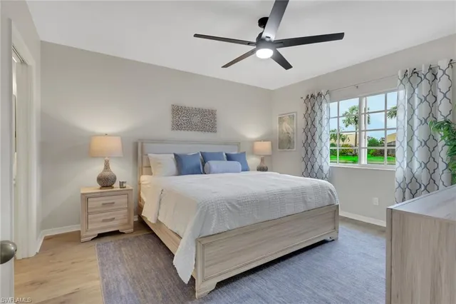 a bedroom with a bed and a large window