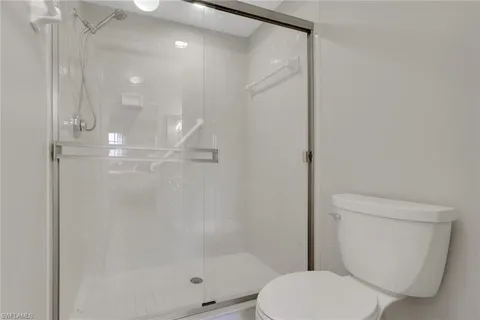 a bathroom with a shower a toilet and sink